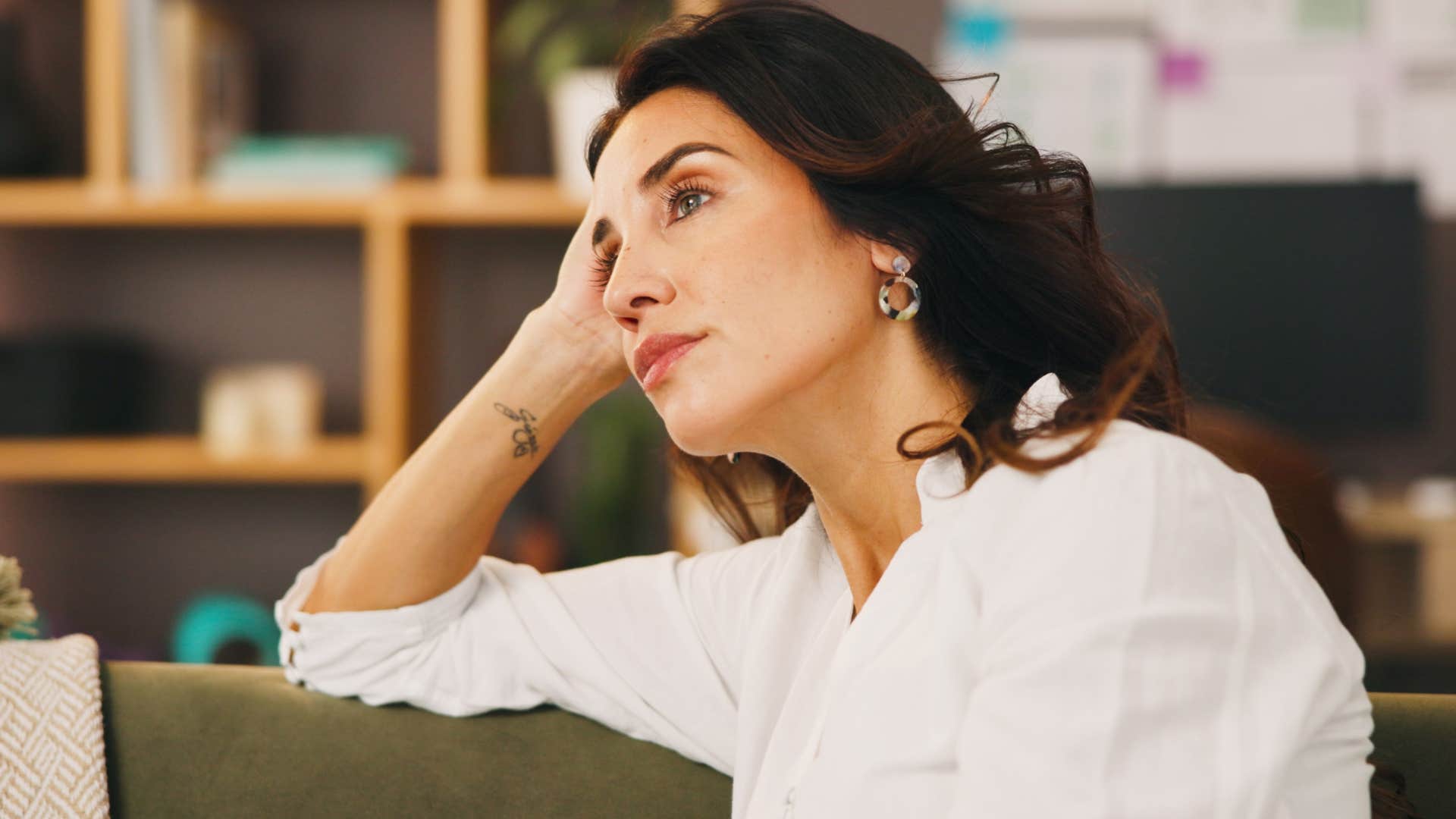 Woman who's an overthinker sitting at home.