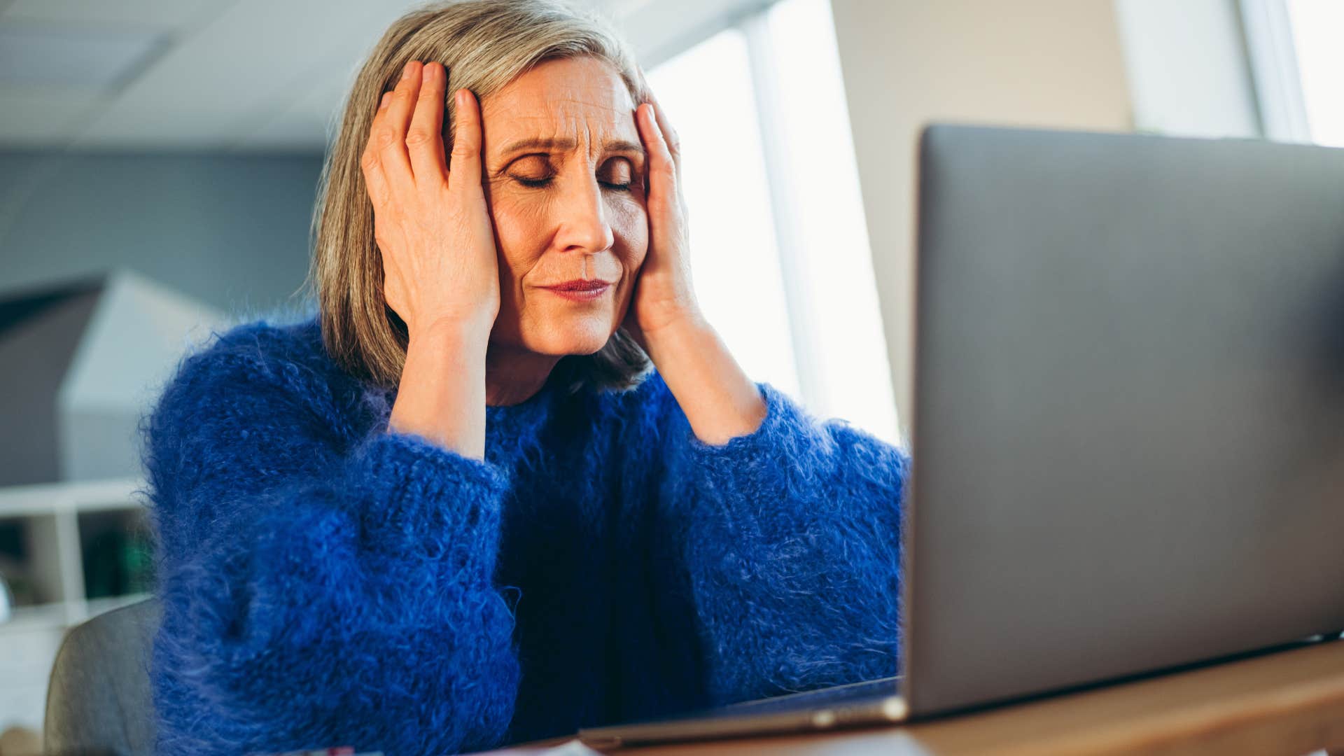 Woman prone to decision fatigue looking stressed at home.