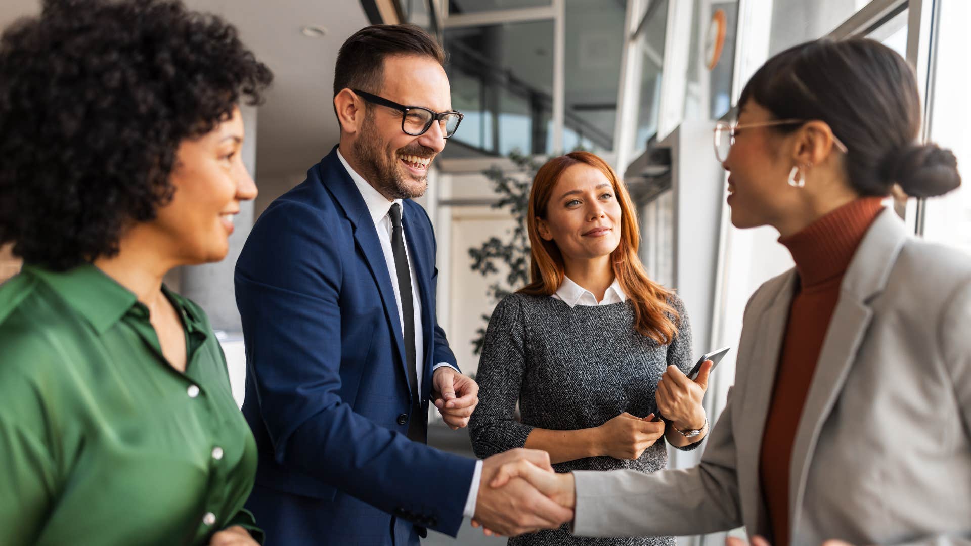 man shaking hands with colleague who is a quiet leader