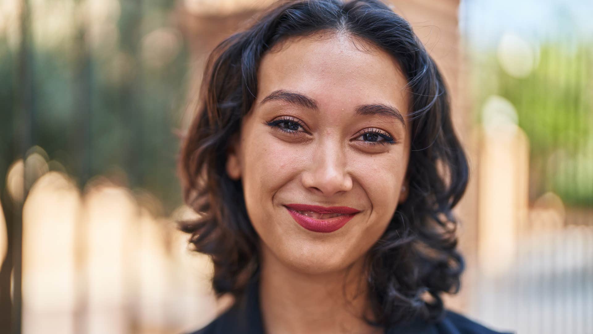 confident woman with a strong sense of ownership standing outside