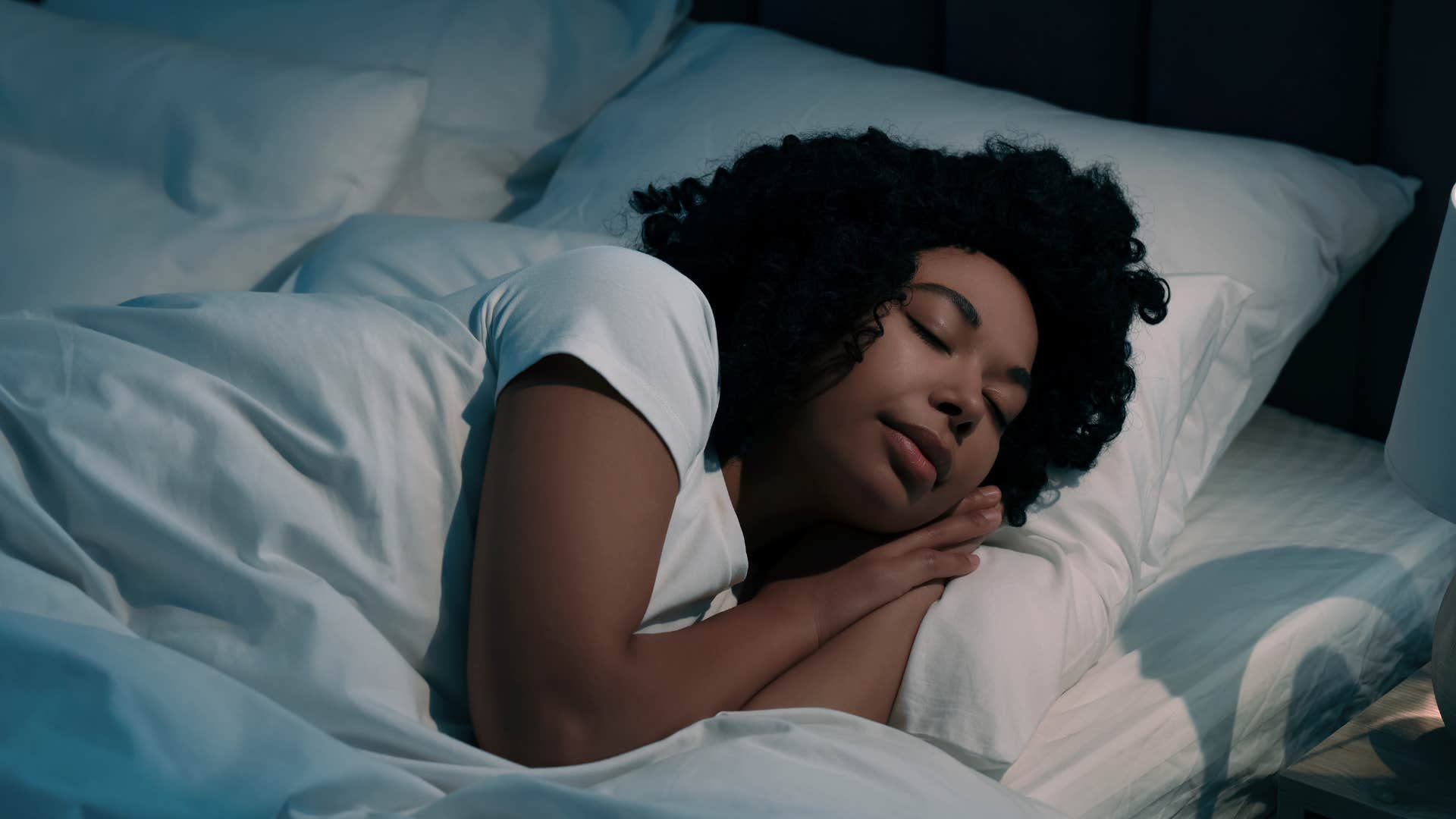 Woman who has strong personal boundaries lying in bed.