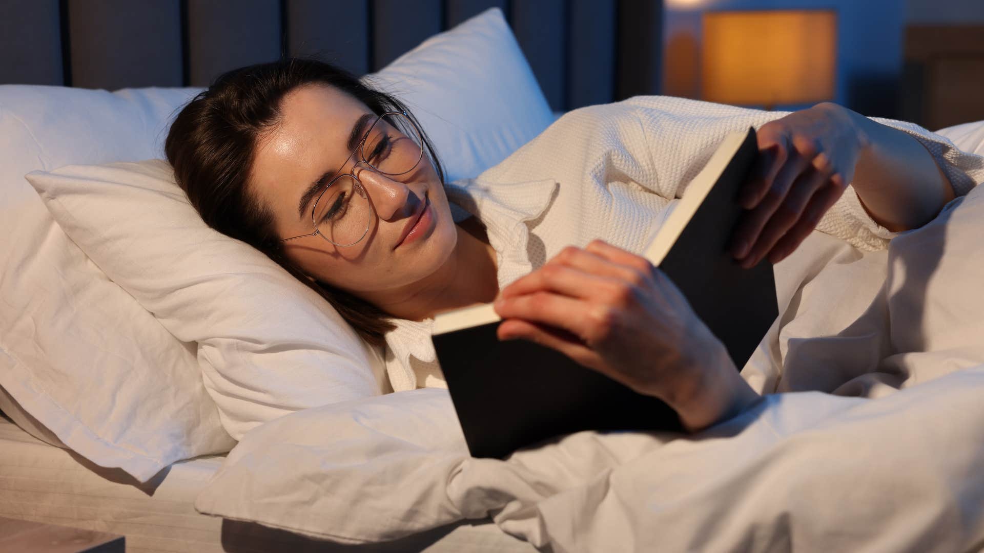 Woman who knows what they need lying in bed.