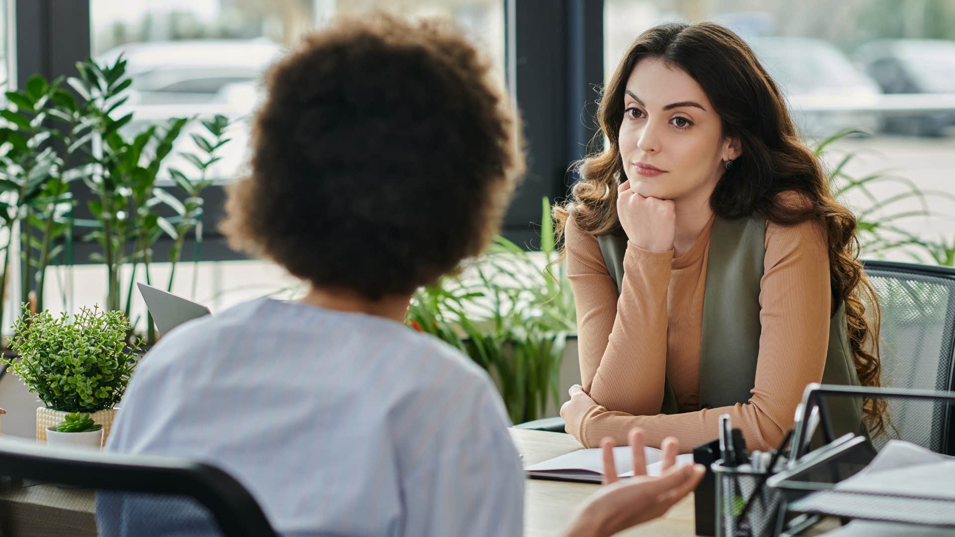 woman who's comfortable with silence talking to a co-worker