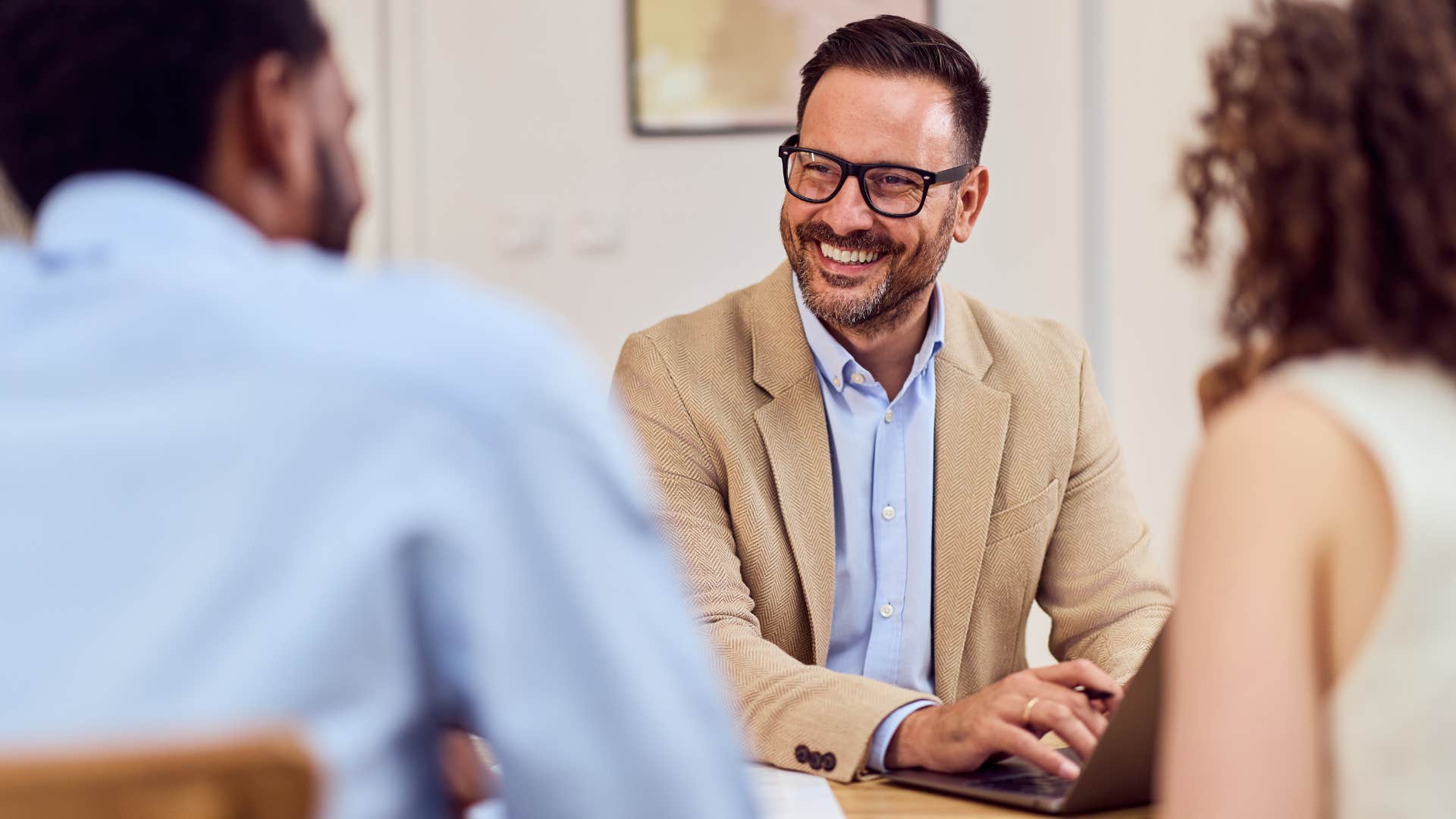 curious man talking to peers at work