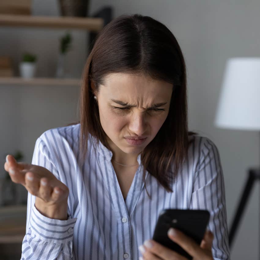 woman who dislikes unpredictability staring at her ringing phone