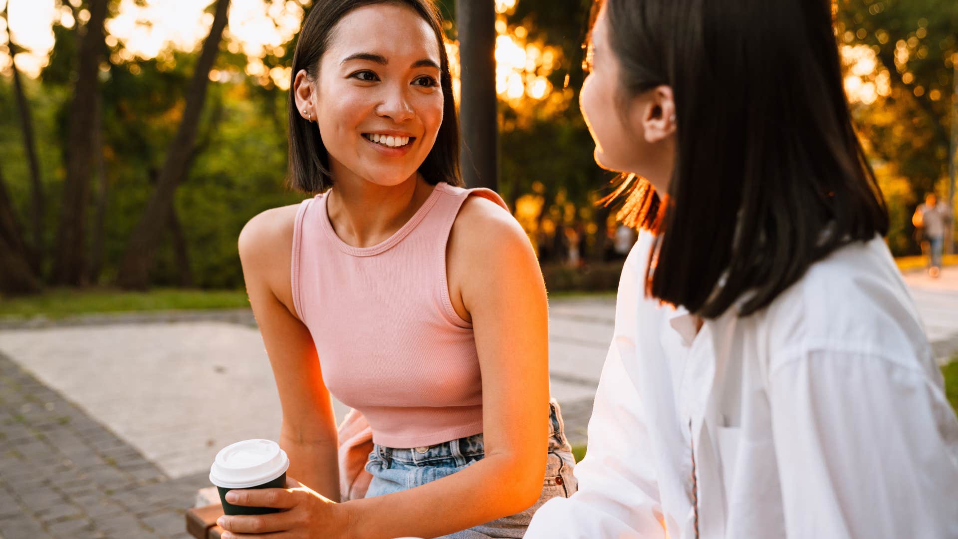 woman talking with friend sitting outside
