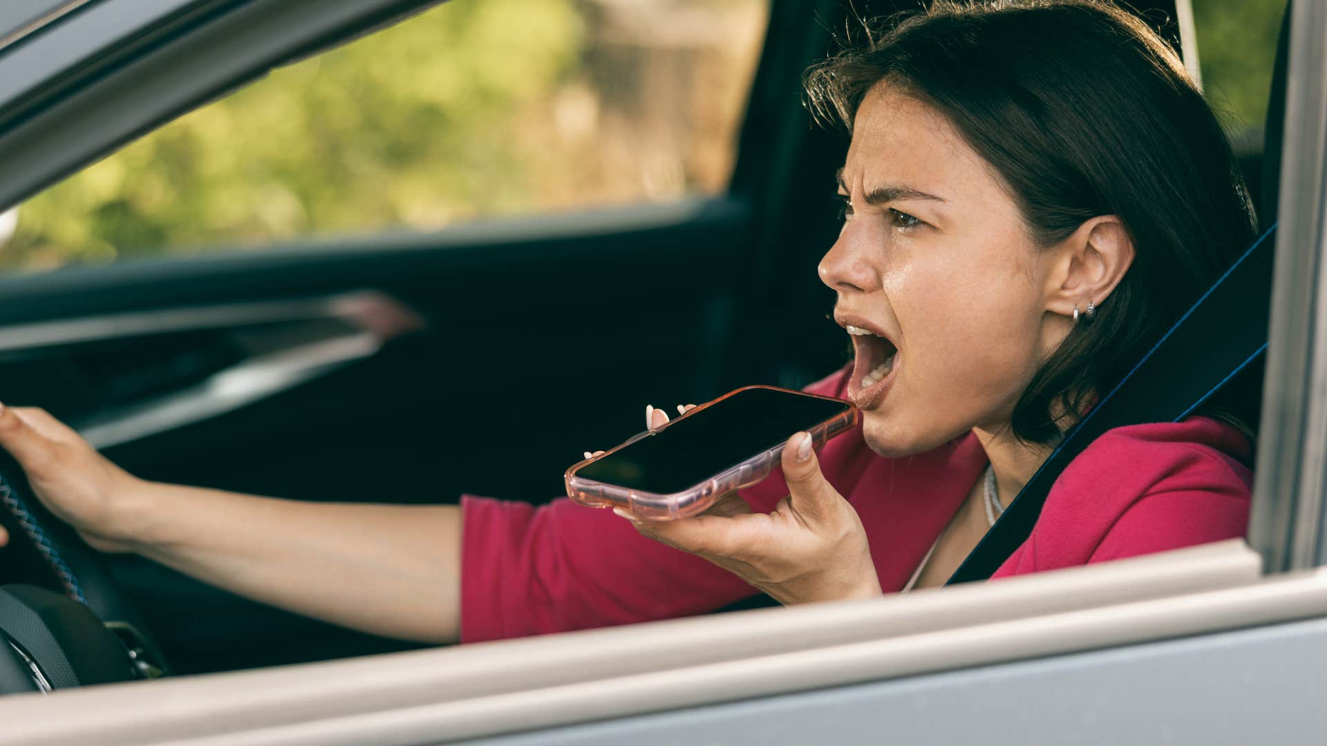 Woman who often seeks control talking in her car.