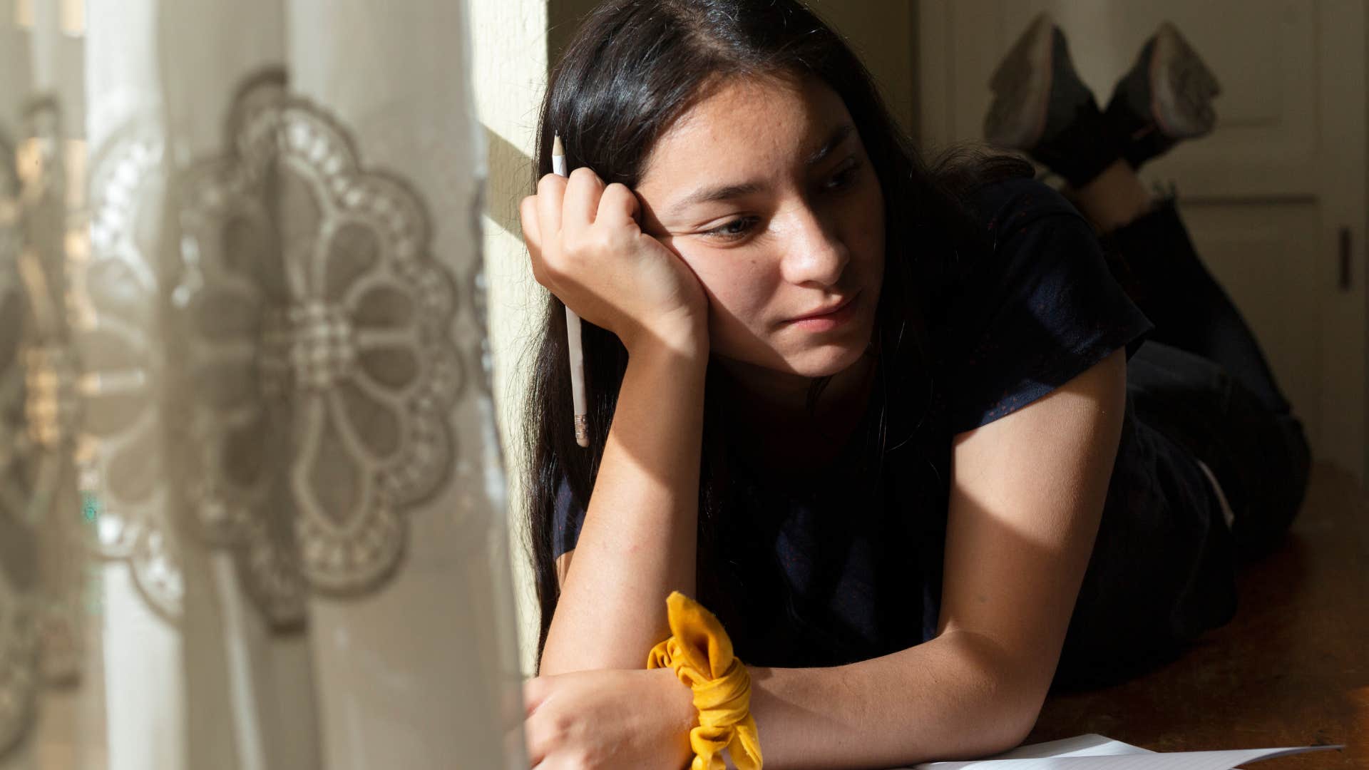 woman who's an intellectualizer journaling at home