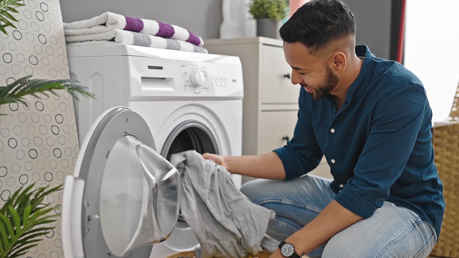 efficient man doing laundry at home