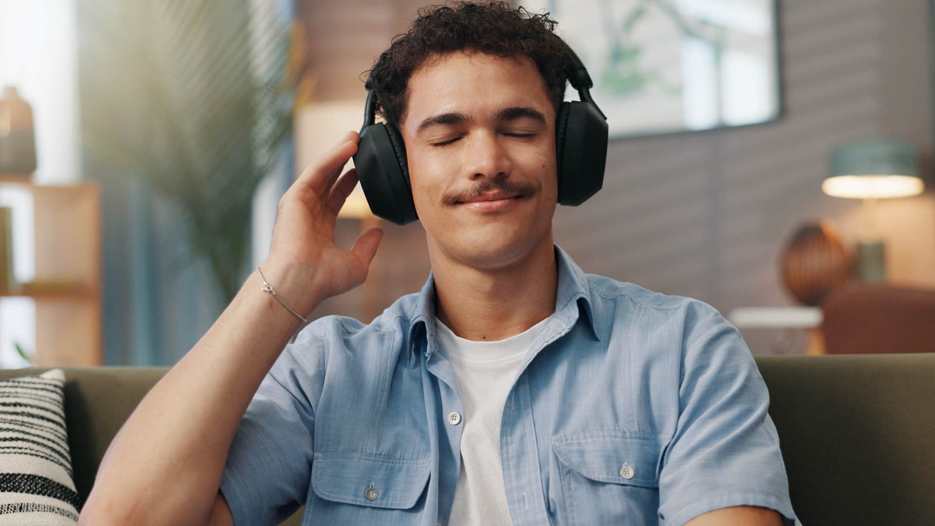 man who's incredibly independent at home listening to music