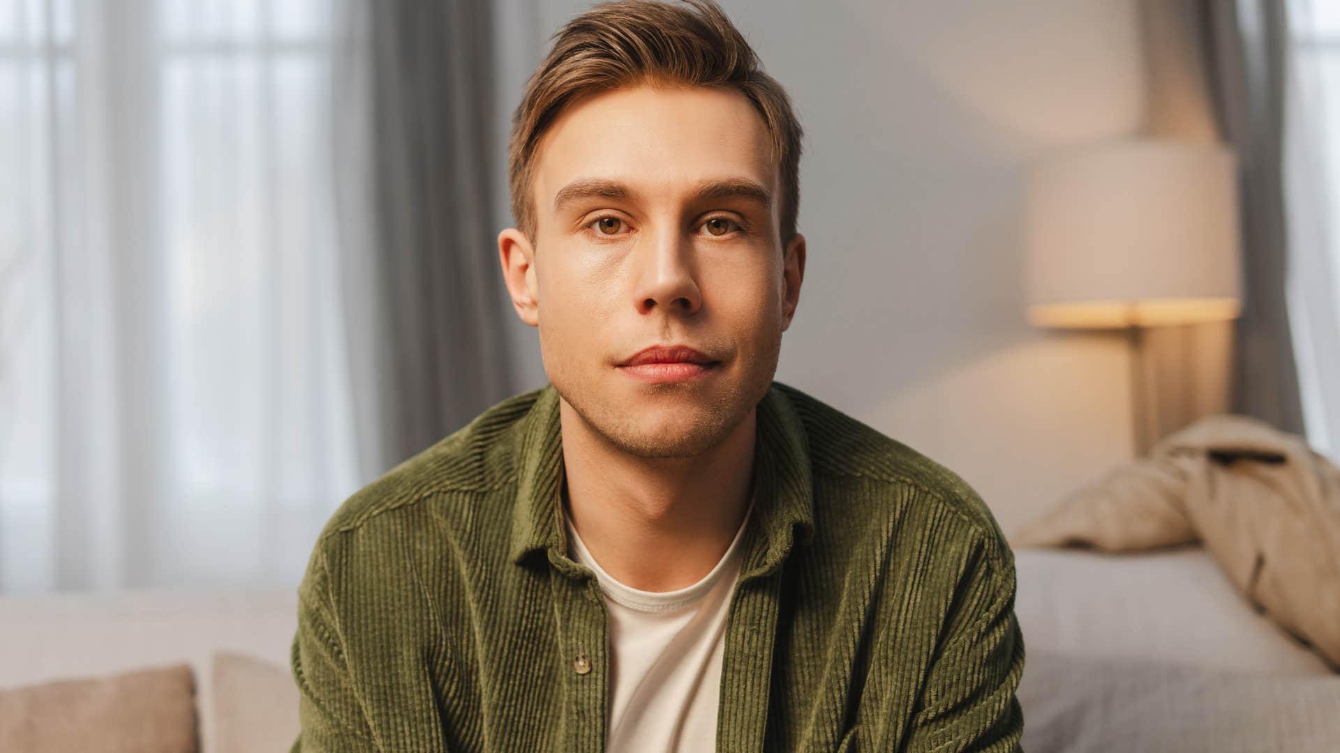 portrait of serious man sitting at home