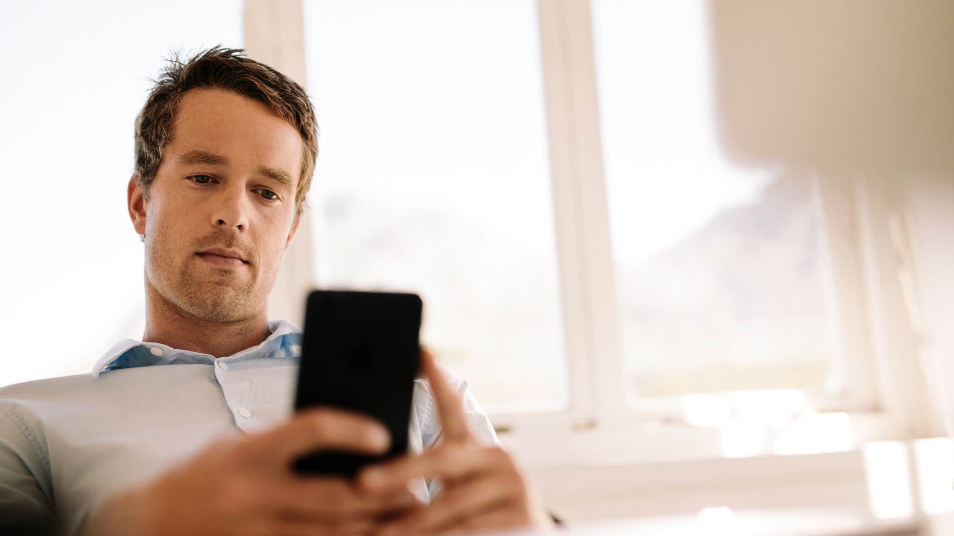 man taking a screenshot he'll never look at again because he's a dreamer