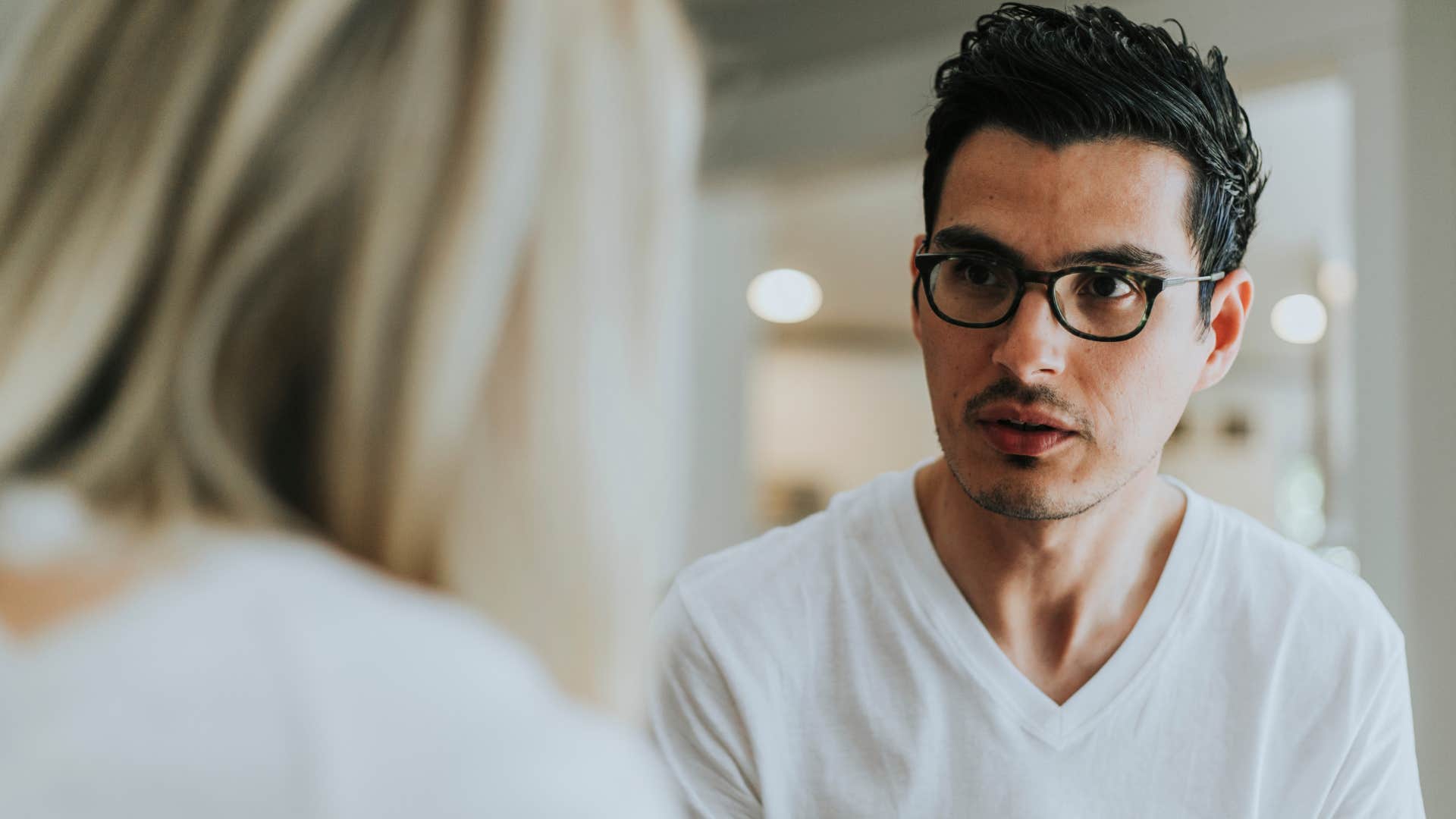 Man saying "no offense, but..." to his wife.