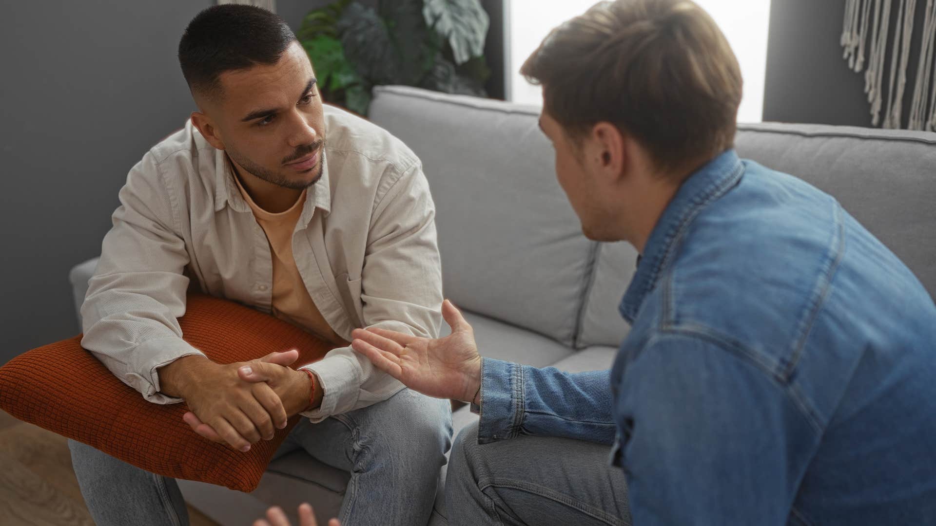 Man saying "I'm surprised you're okay with that" to his friend.