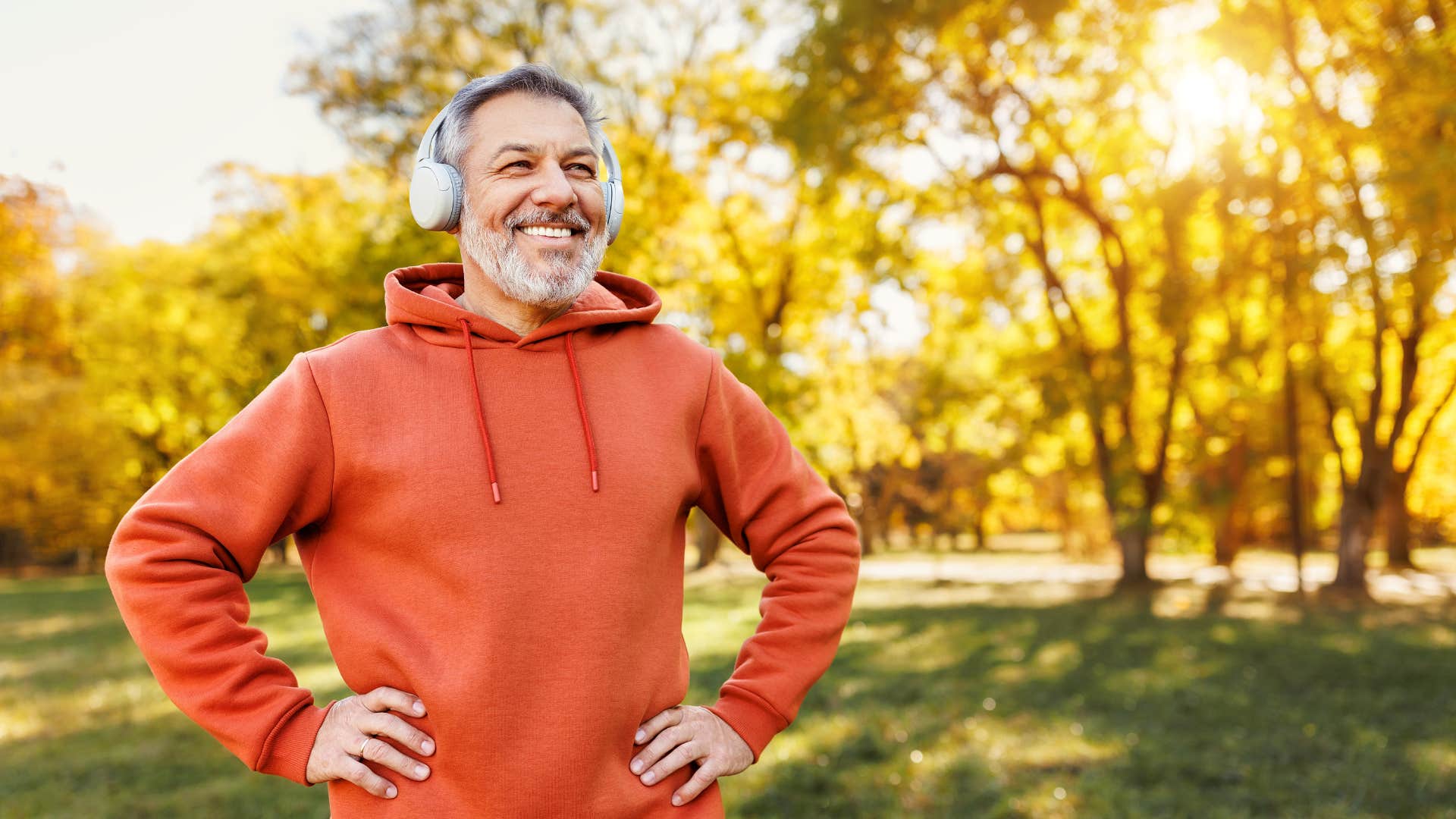 Happy person wears headphones showing music helps age more slowly