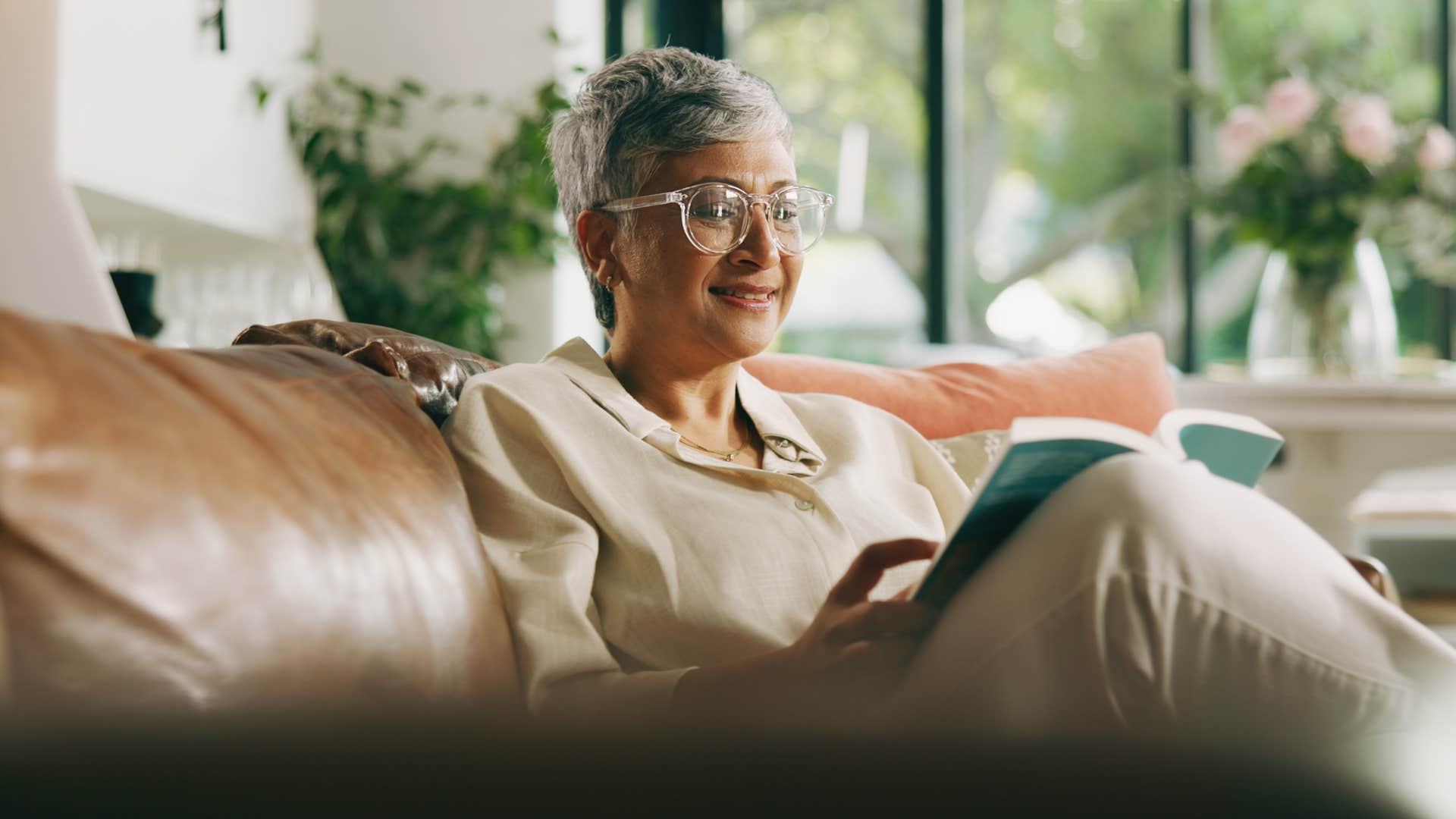 Aging person reads book showing way to expand vocabulary
