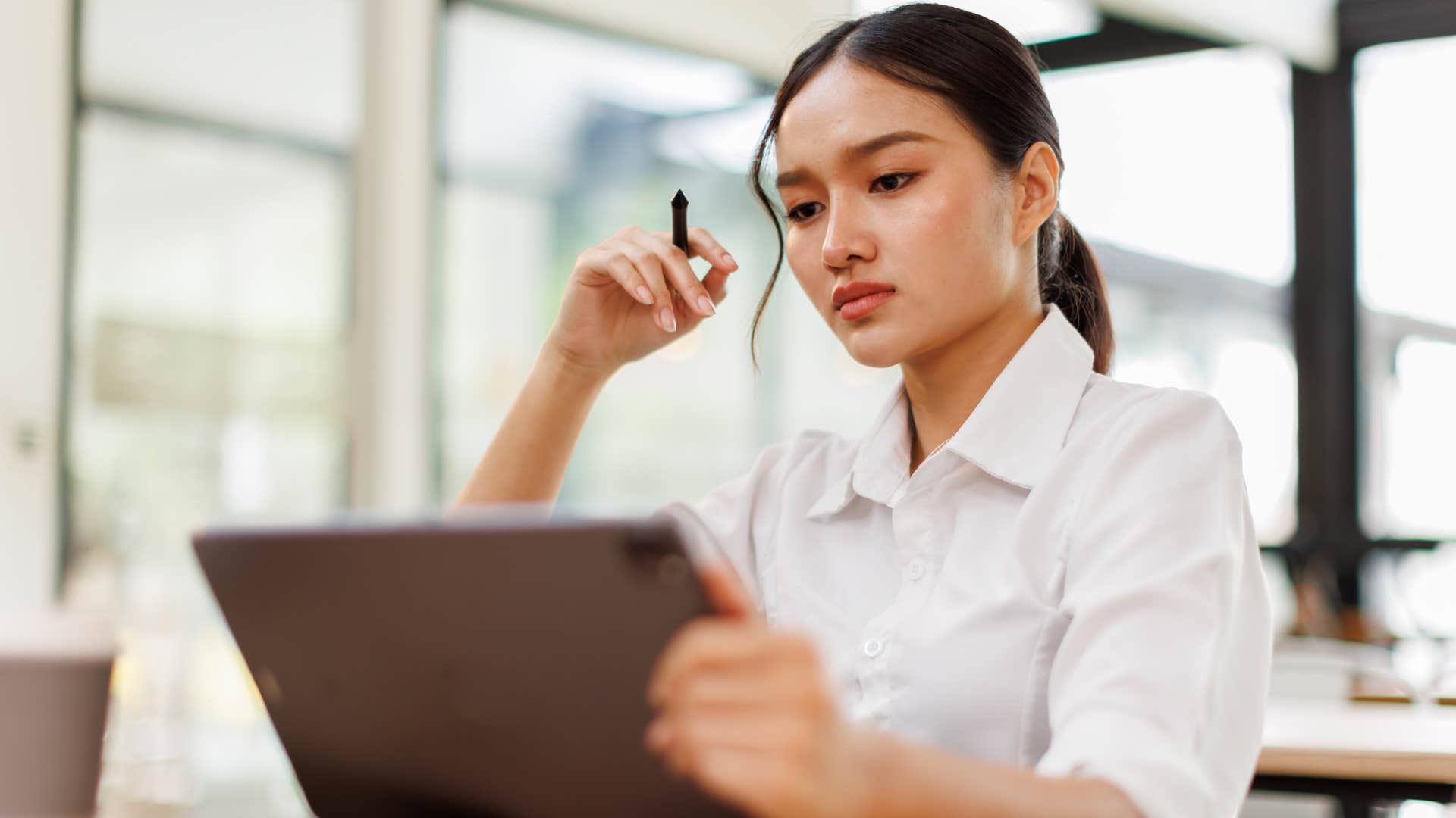ambitious woman working in an office shaking her leg while sitting