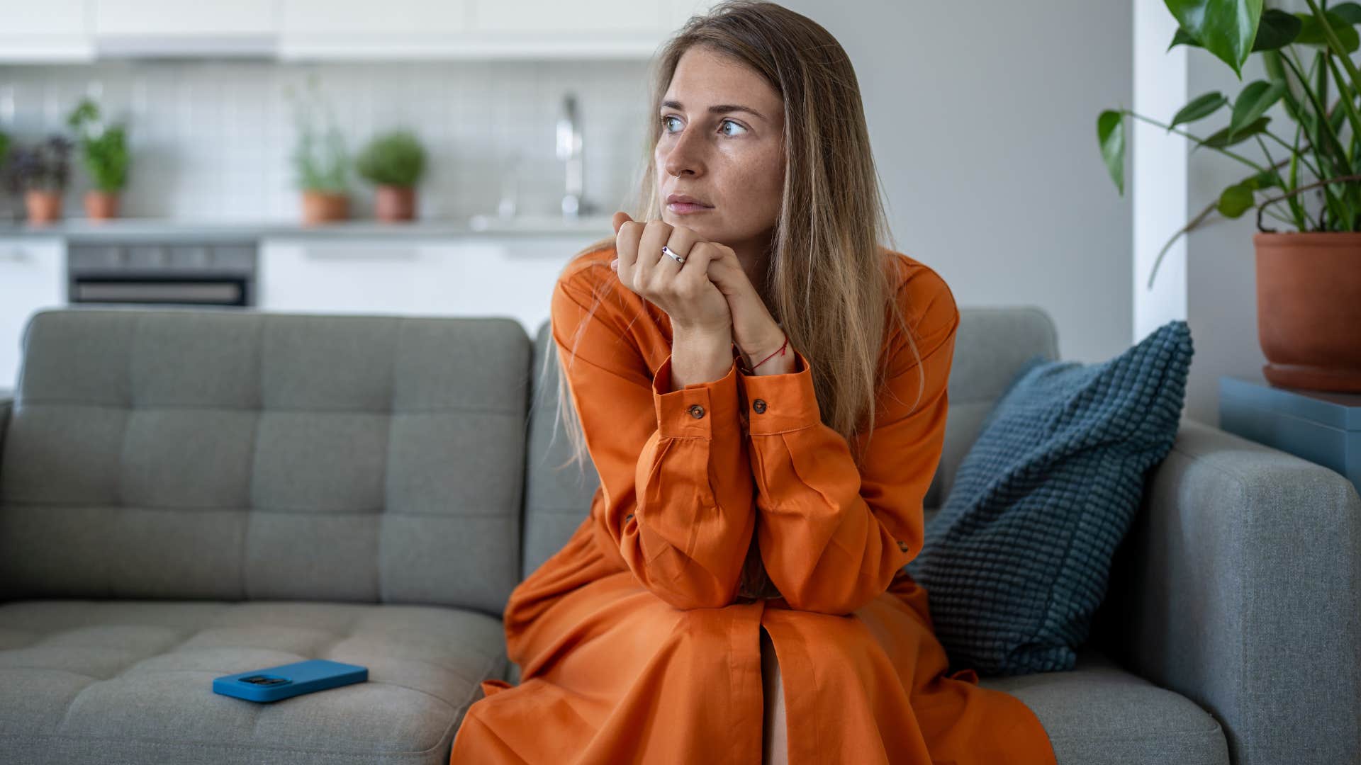 anxious woman sitting at home shaking her leg