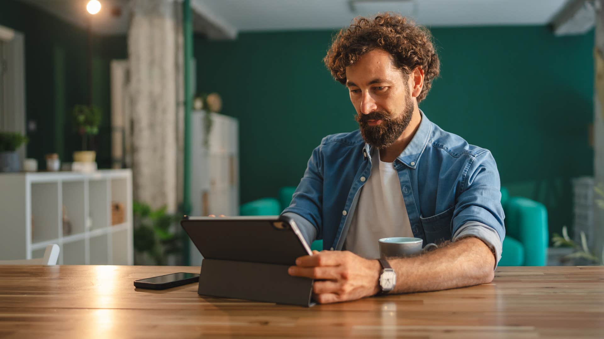man who thinks one step ahead looking at his laptop