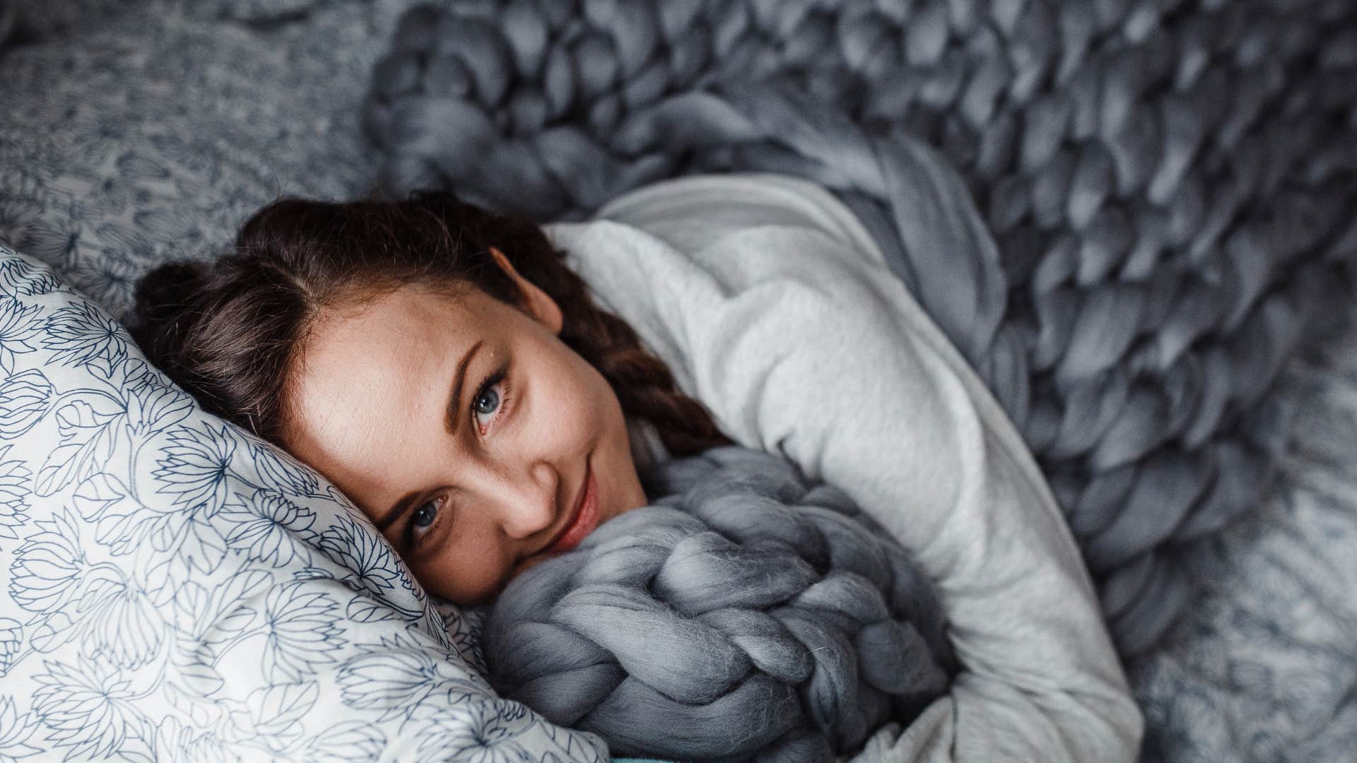 woman who sleeps better with socks on because she has a preference for comfort