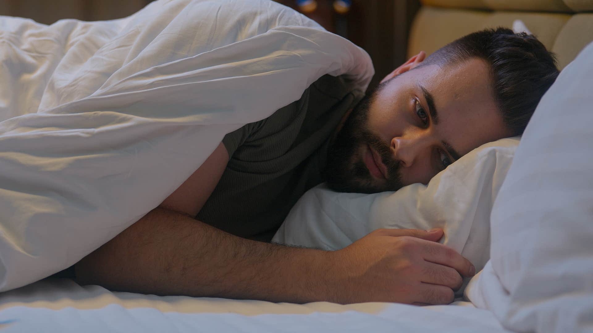 man who has rich inner world lying awake in bed