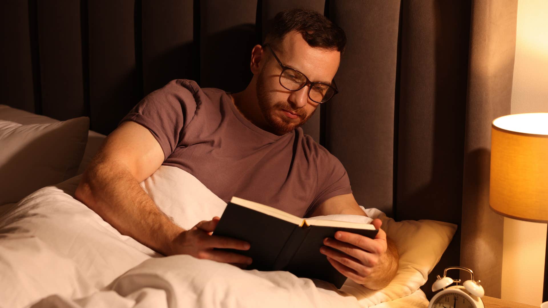 man who's intentional about his energy reading in bed