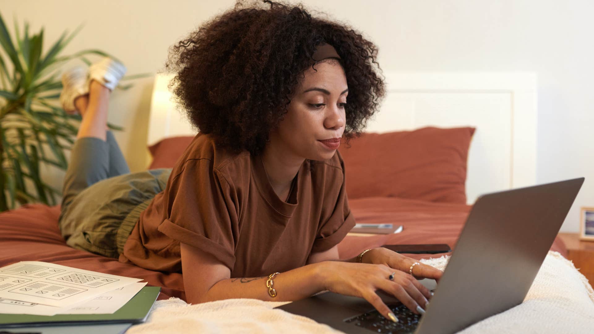 woman who prefers planning and structure working in bed