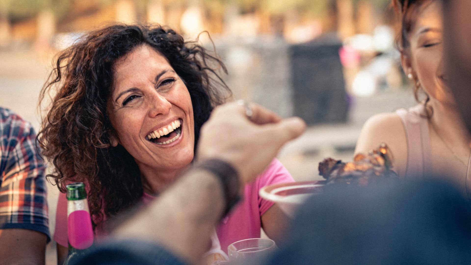smiling woman laughing with friends finding meaning in small moments
