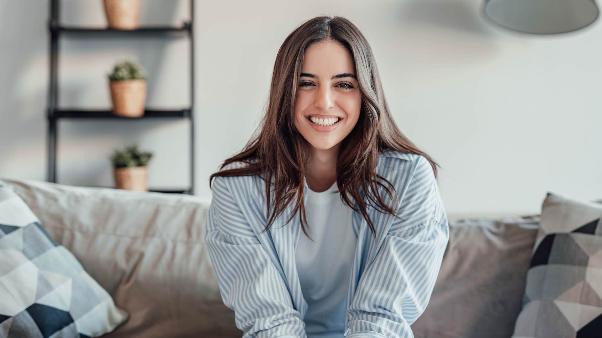 happy woman feeling secure in herself sitting at home