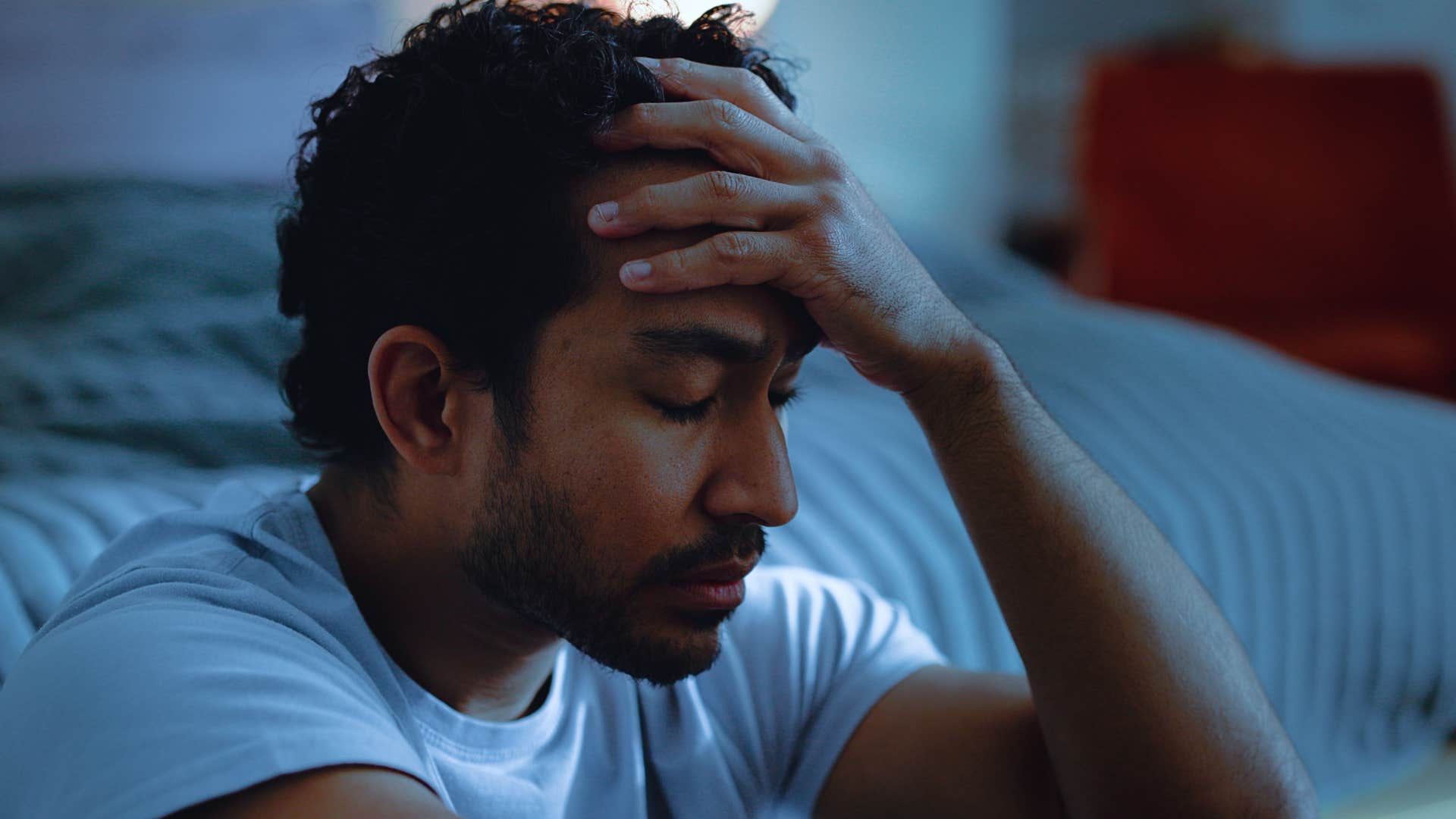 man whose brain is always on sitting in bed wide awake