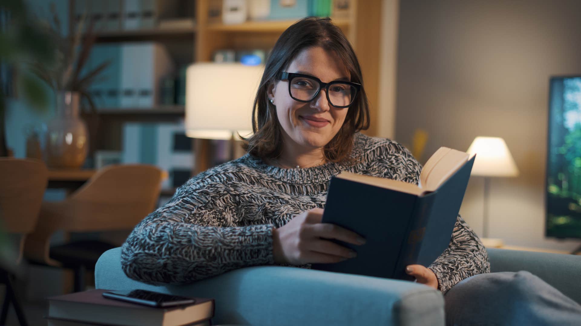woman who's well regulate reading at home late at night