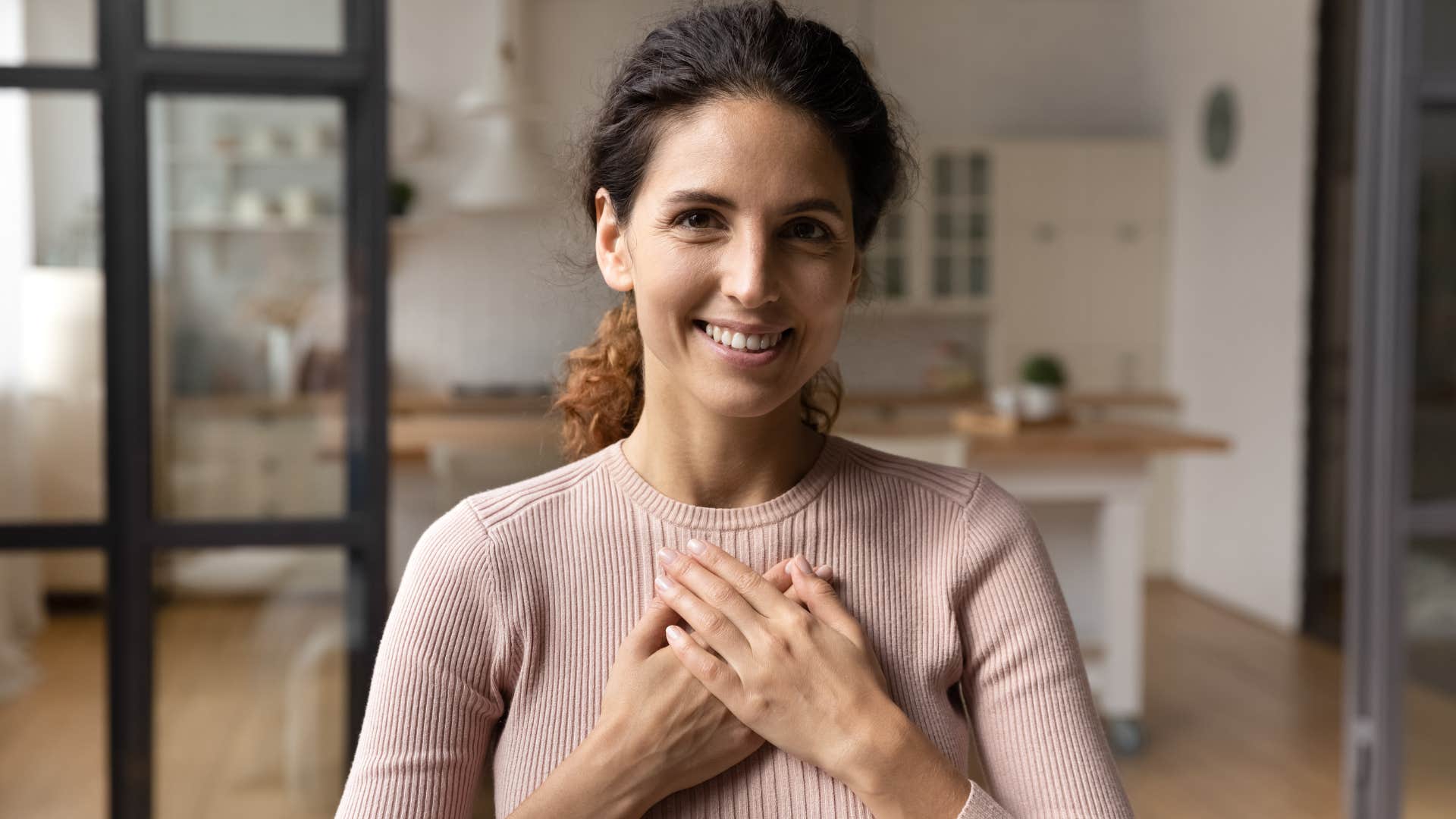 woman holding her hand over her heart believes kindness matters