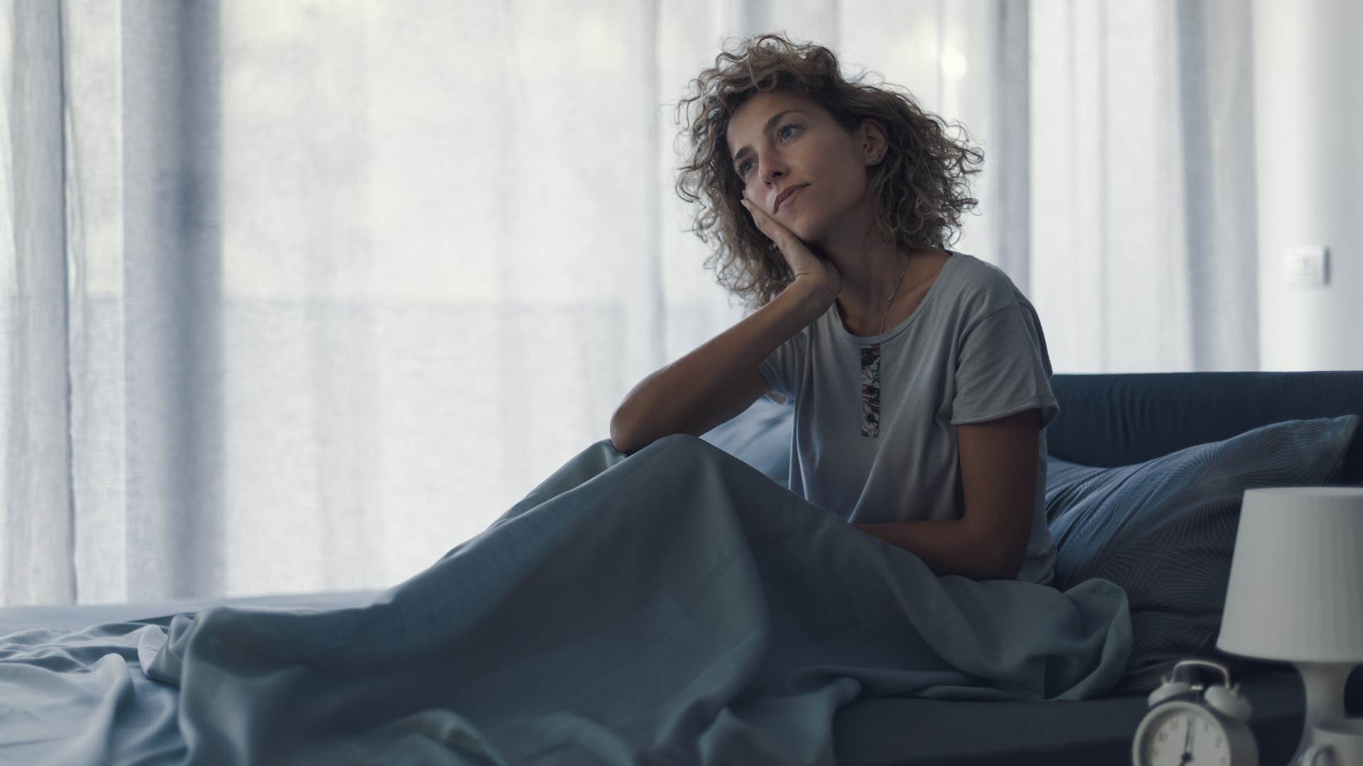 woman waking up from sleep trying to remember her dreams