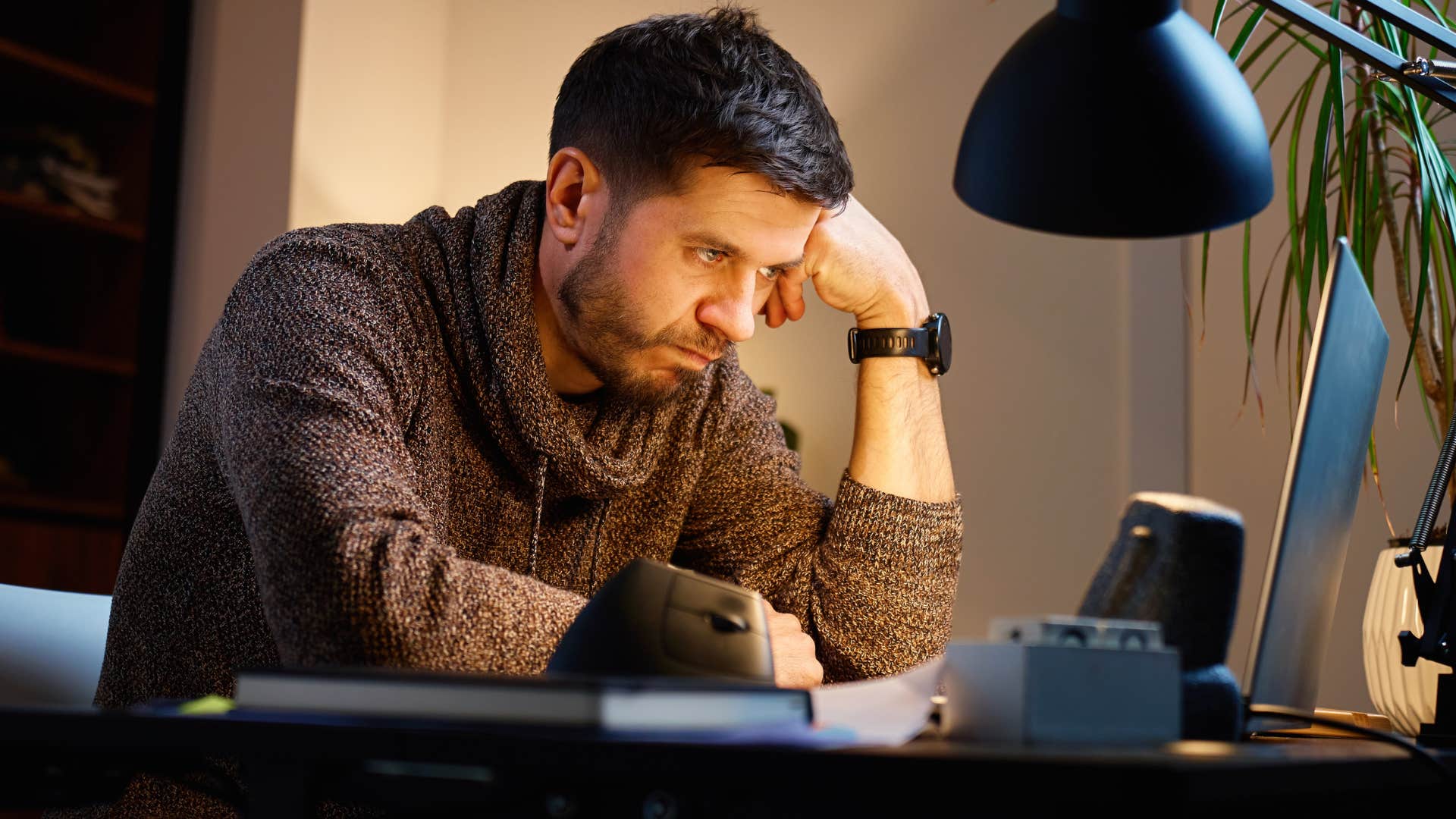 perfectionist man working late on his laptop