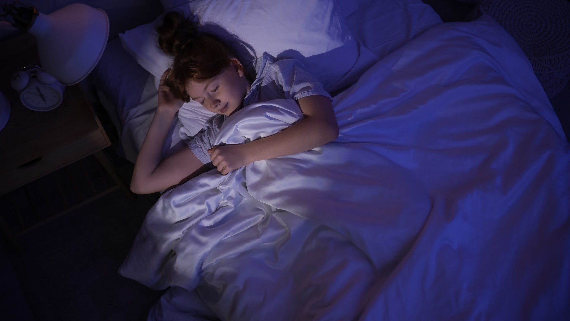 woman who wakes up before alarm goes off and avoids heavy stimulation at night