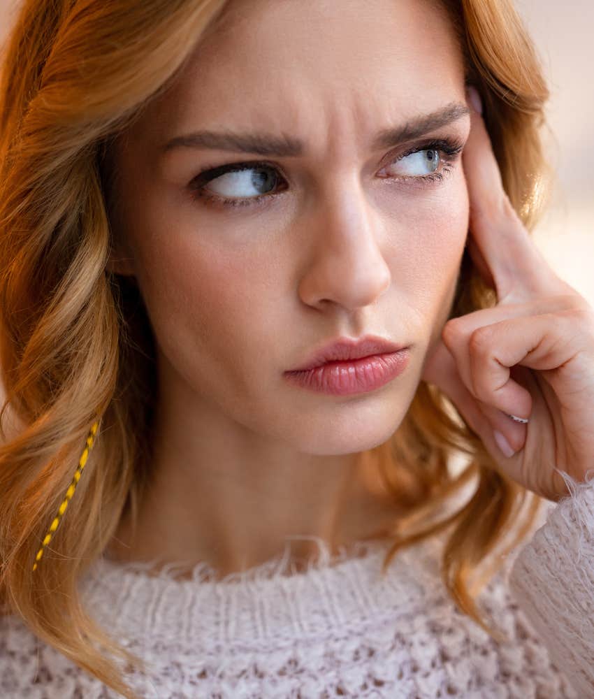 Serious person with finger on temple considers their big dreams