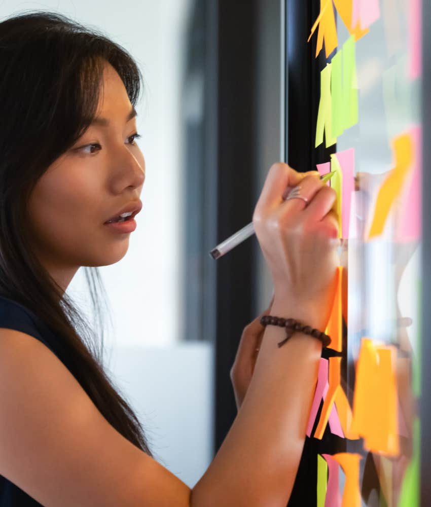 Focused person with vision board plans nest steps