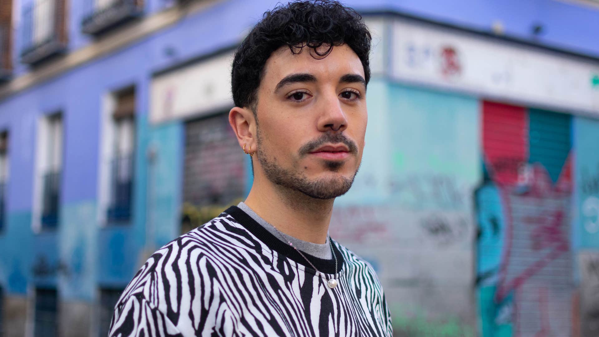 man standing in street looking at camera