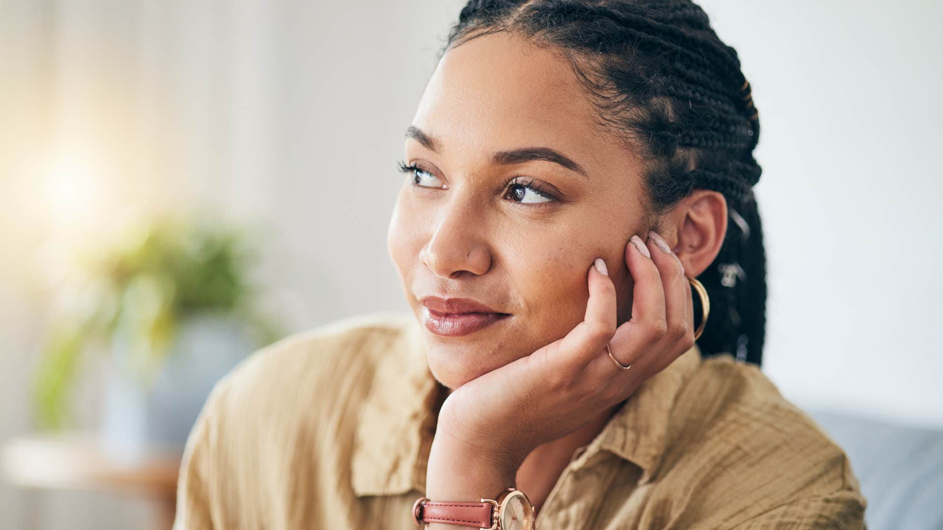 woman thinking with hand on her cheek