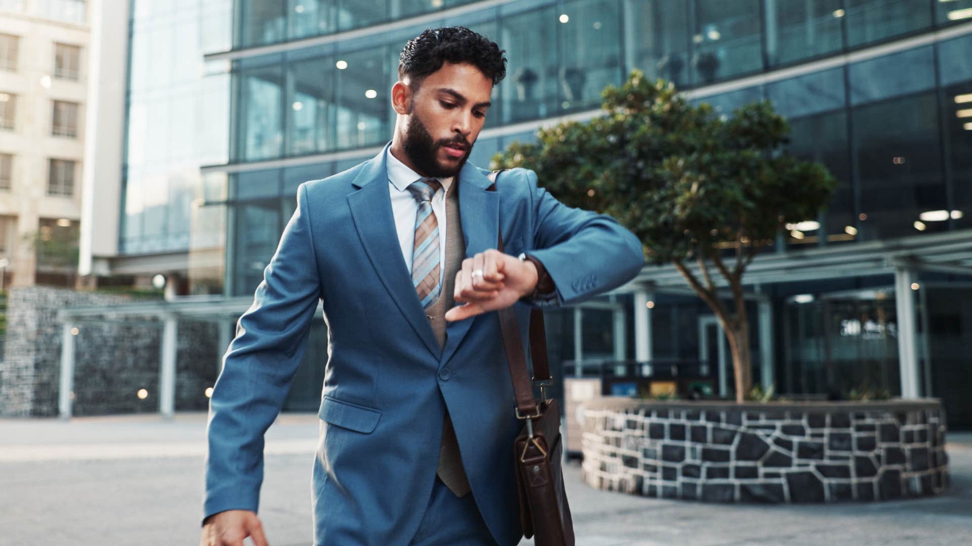 man in suit checking watch as he doesn't have time to think about it
