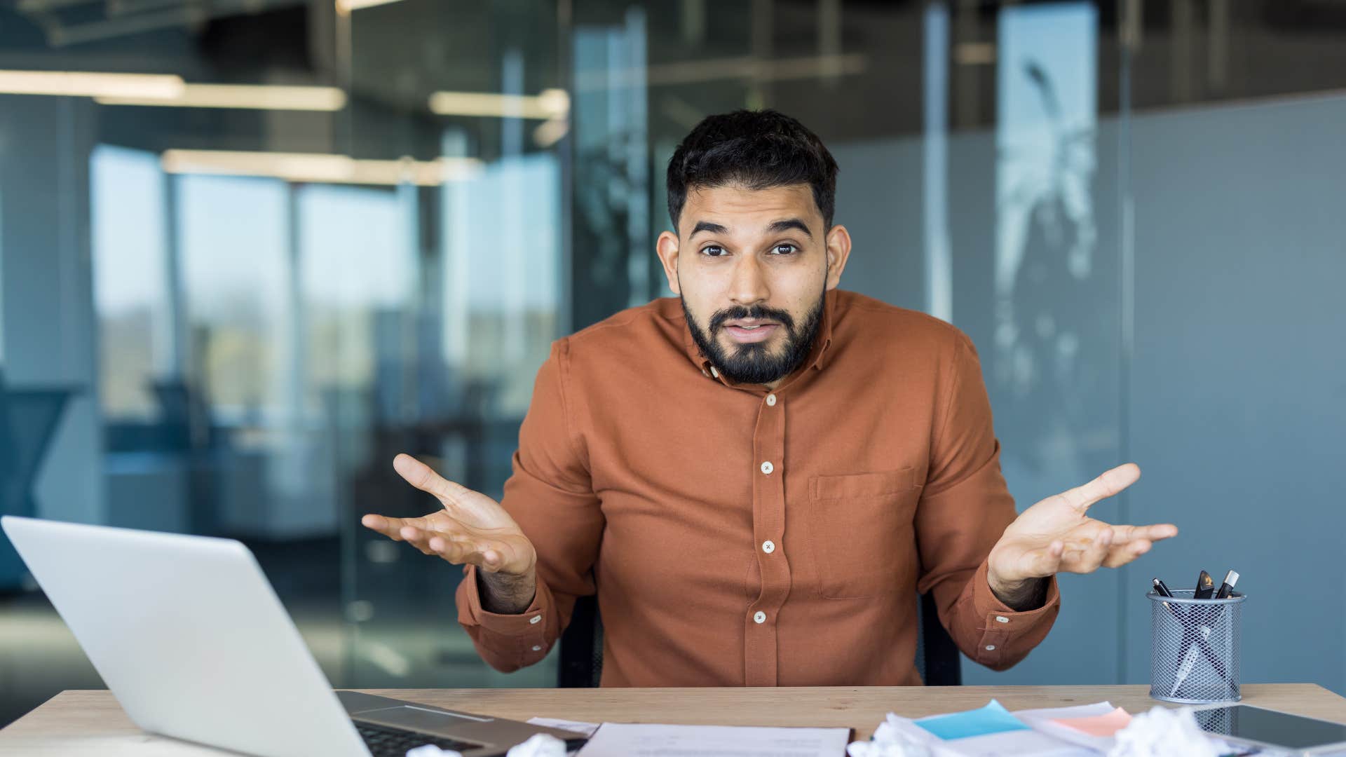man in brown shirt shrugging as he says that's just how I am