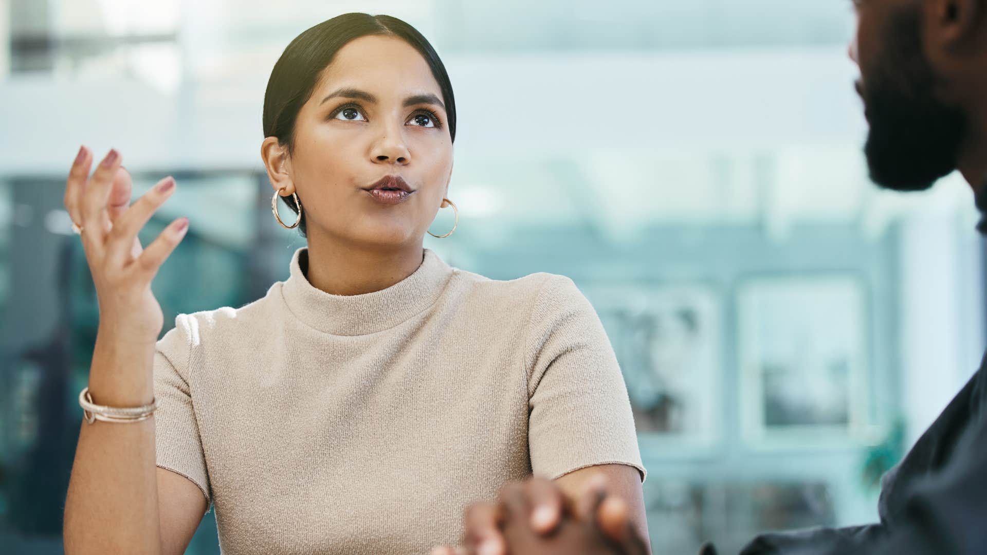 woman giving short dismissive answers to colleague