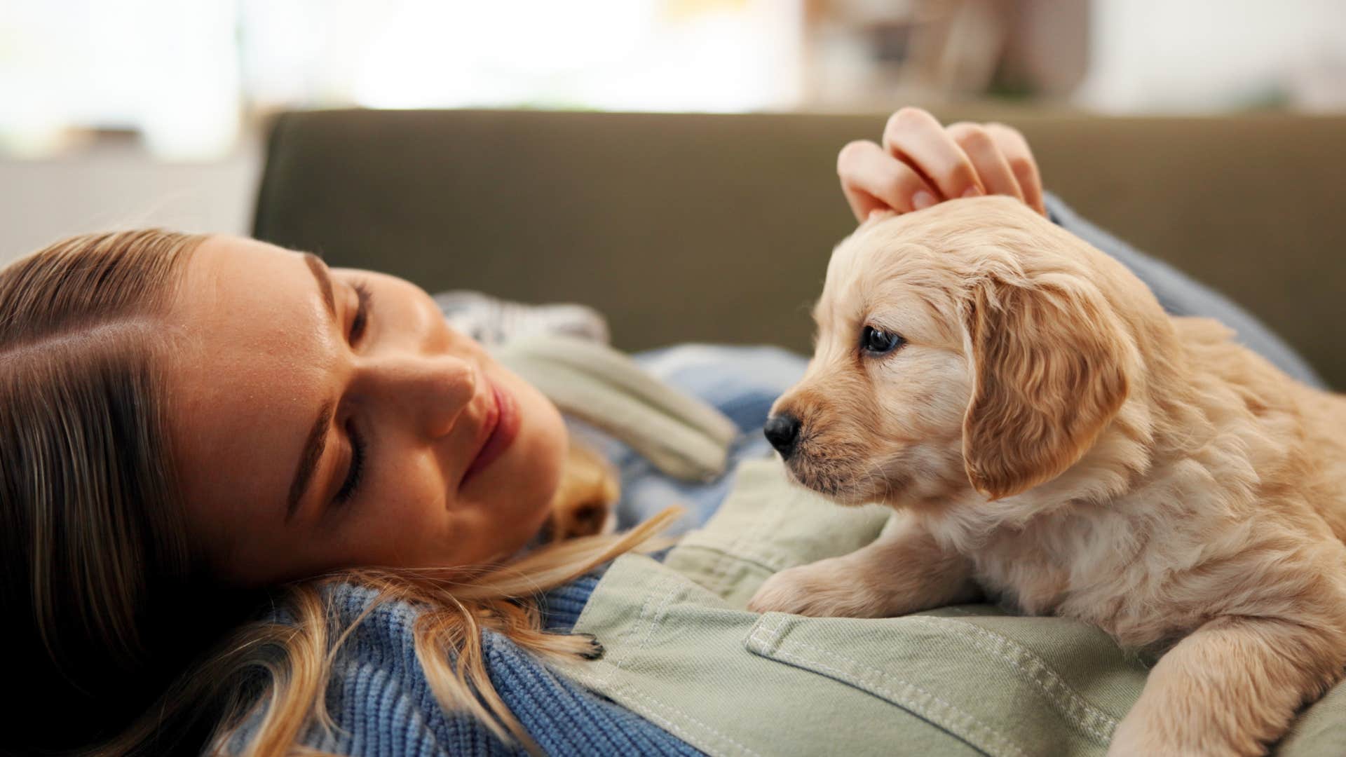 woman petting puppy