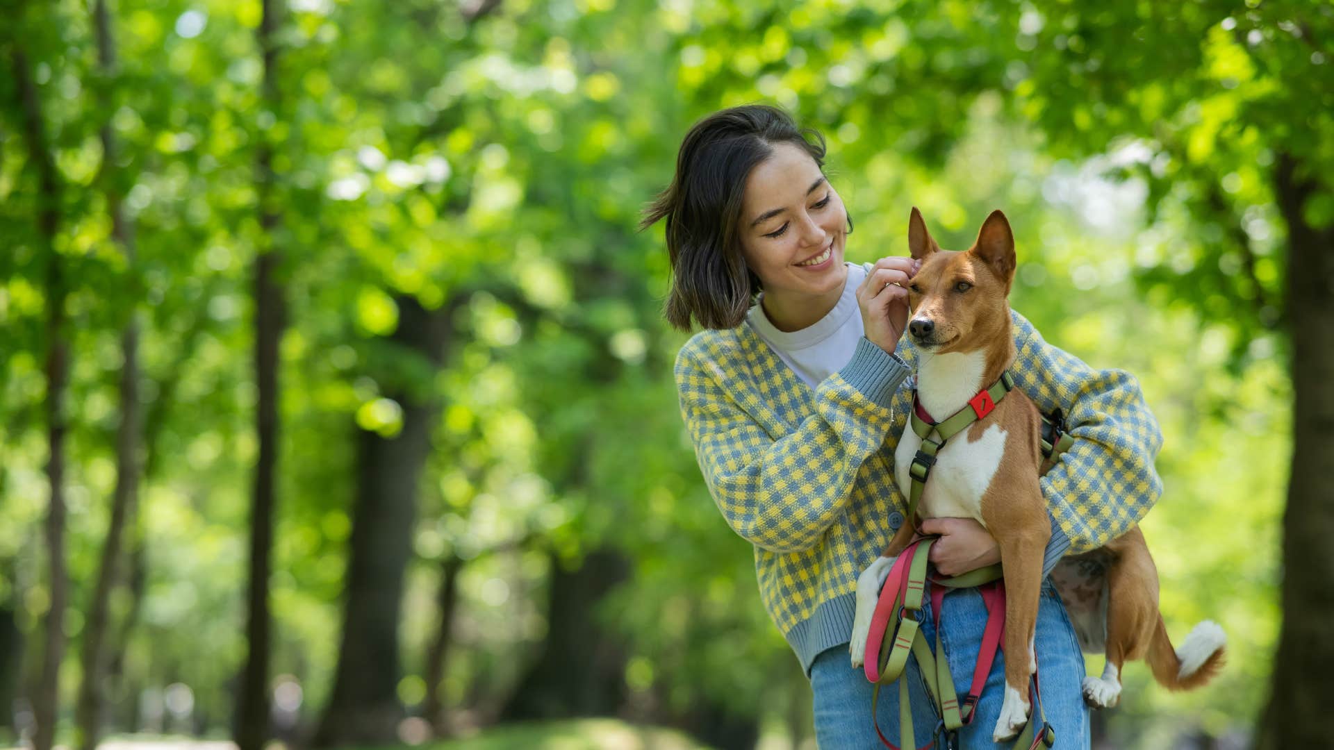 woman holding dog outside