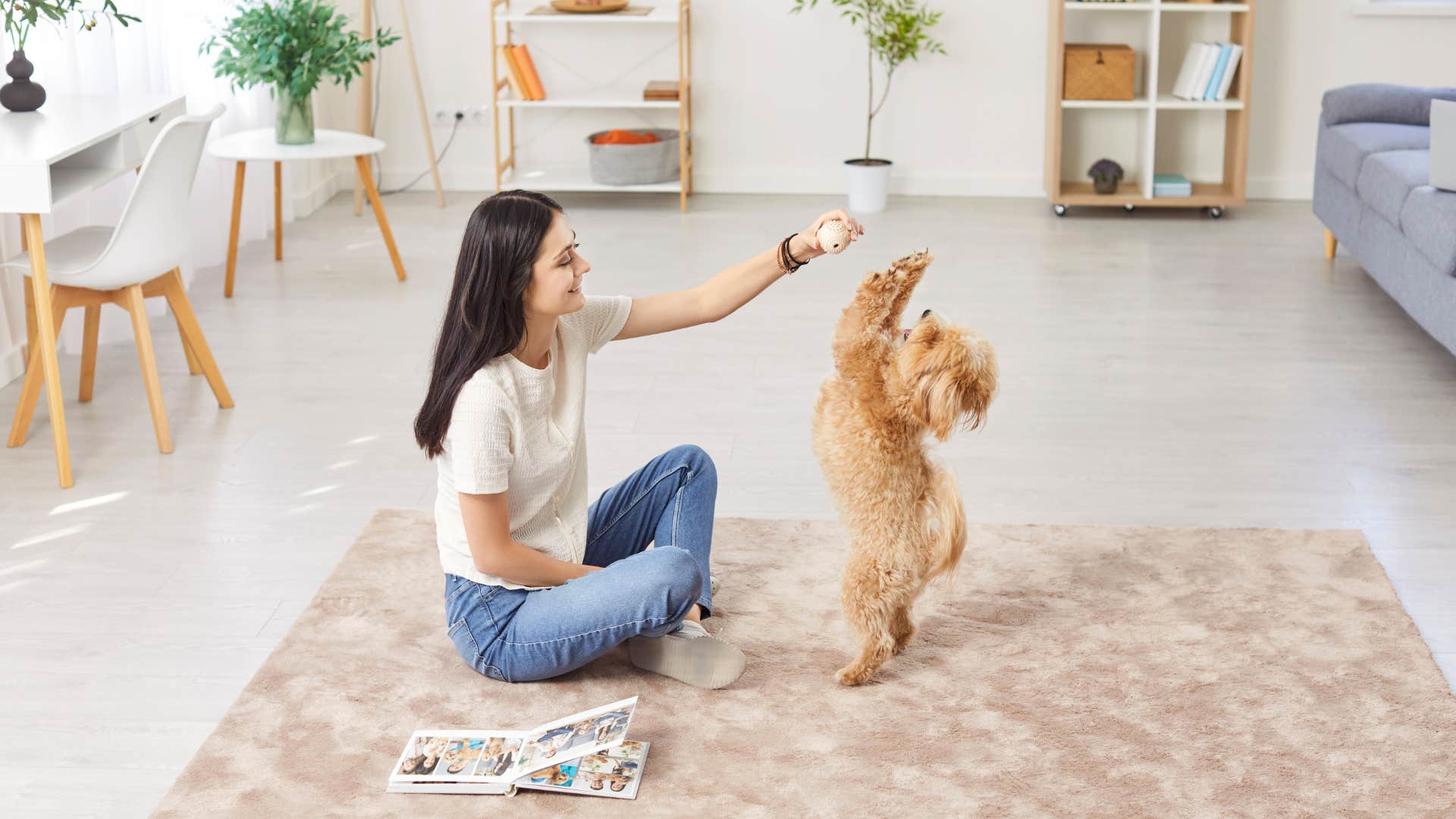 woman playing with dog