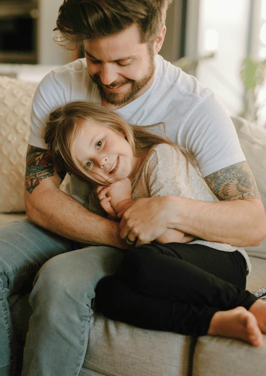 playful man hugging child close