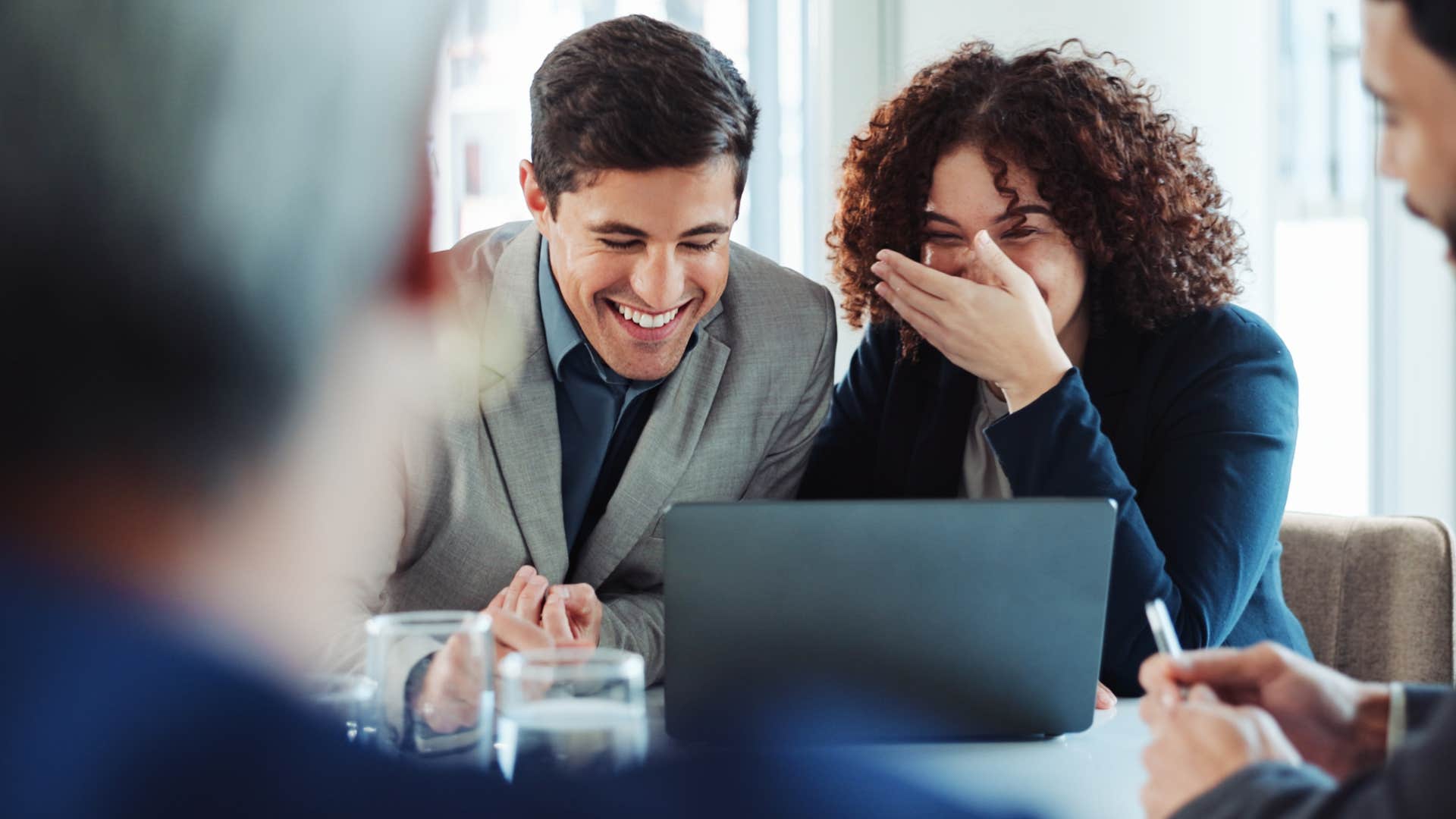 woman saying we get along fine, as long as we ain't in the same room to her colleague laughing