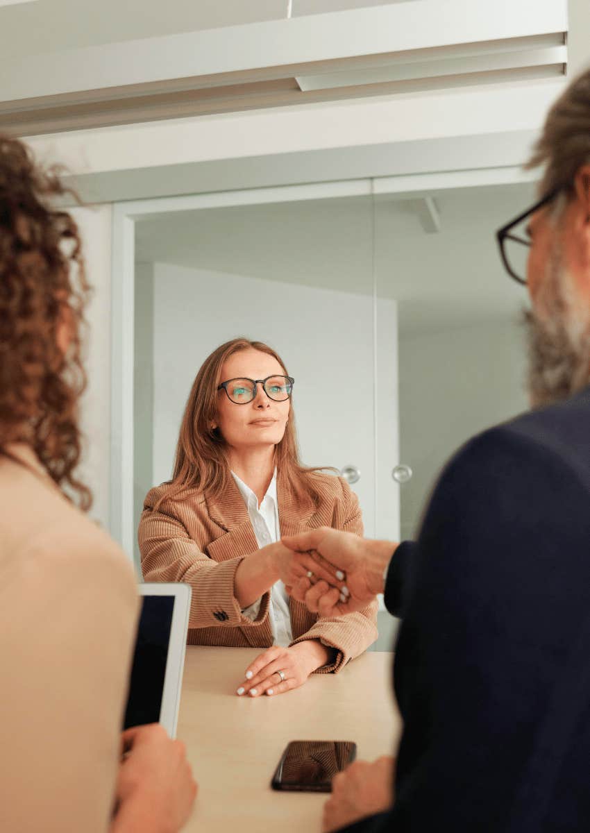 professional woman as a new hire shaking hands with management
