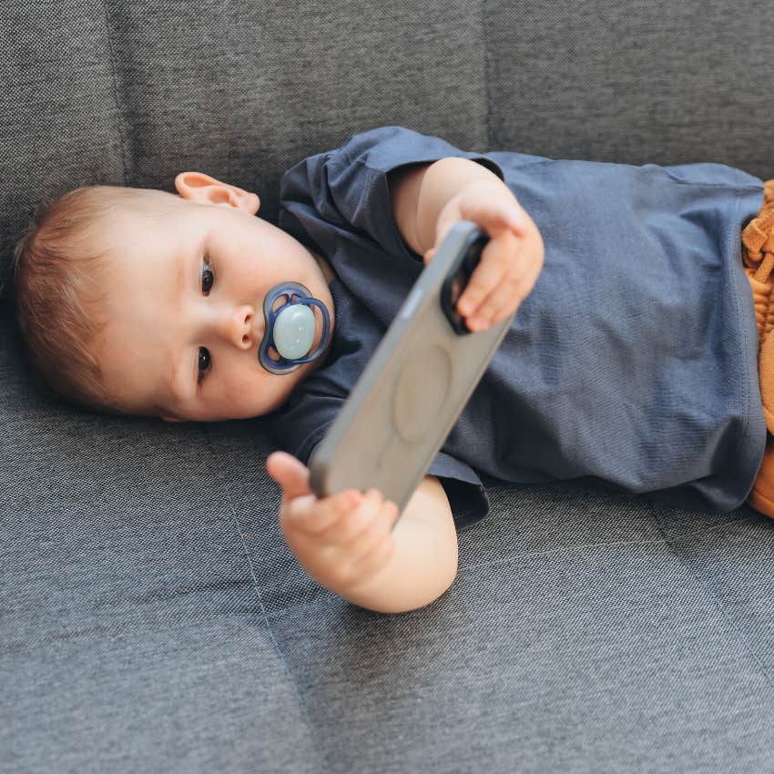 toddler lying on couch watching overstimulating content screen