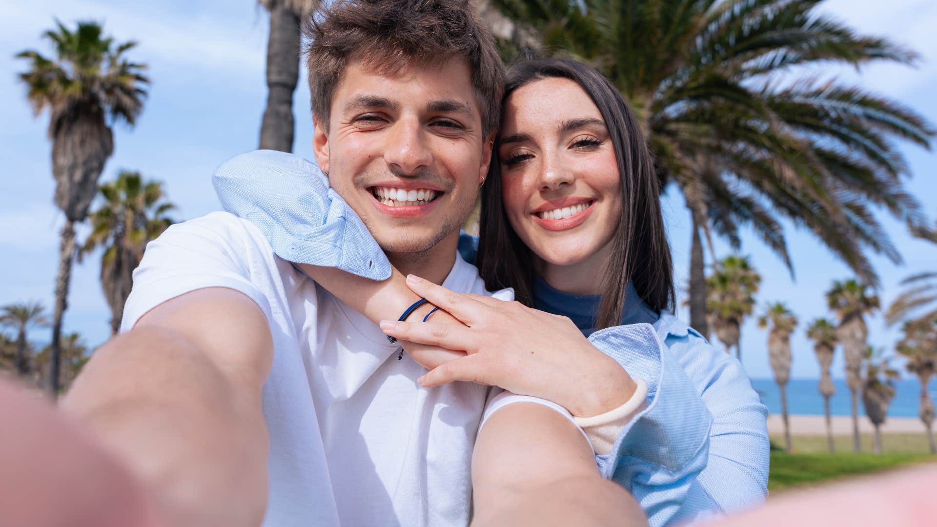best friends who are also partners taking a selfie together